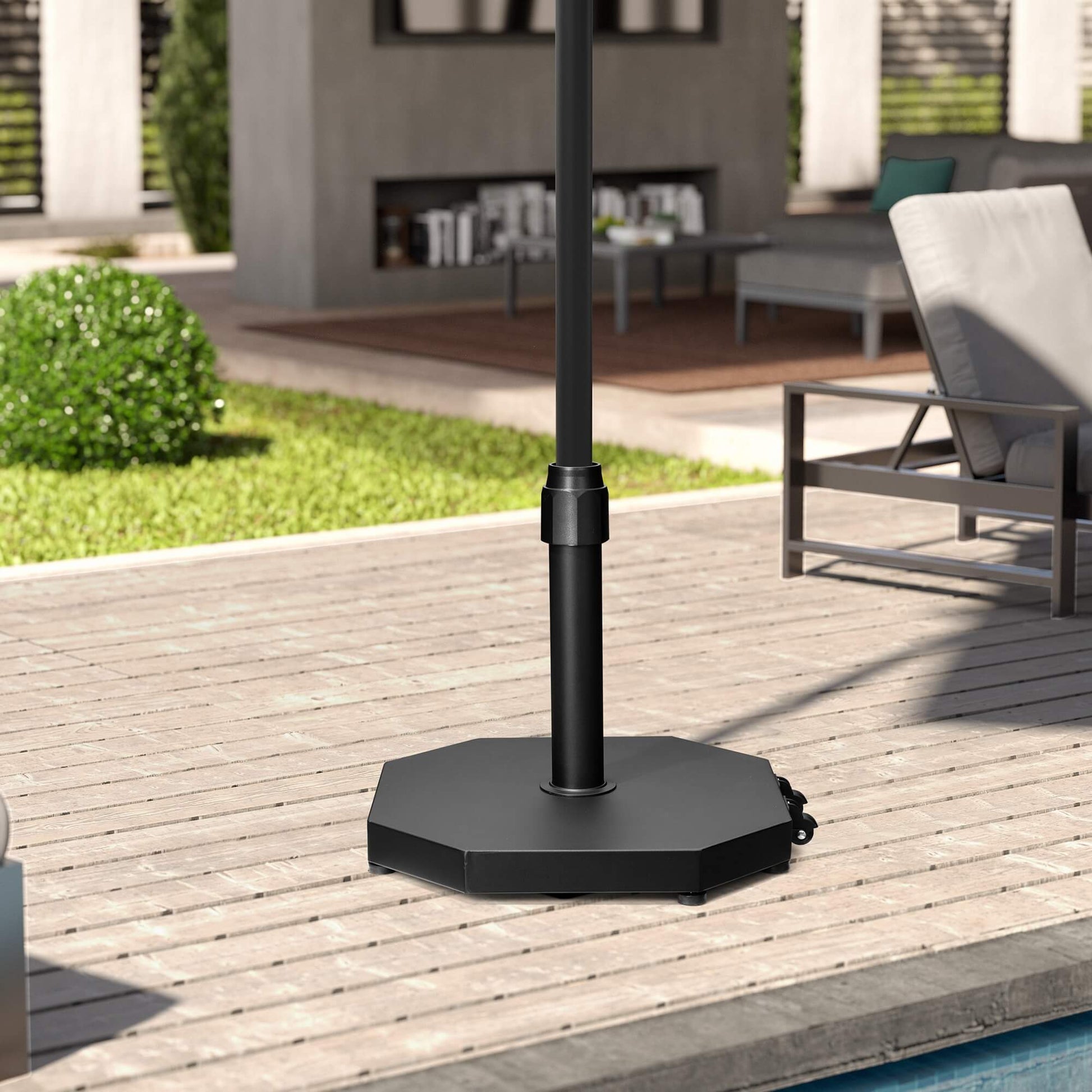 Black 40 lbs octagonal cement market umbrella base with wheels on a residential wooden patio deck.