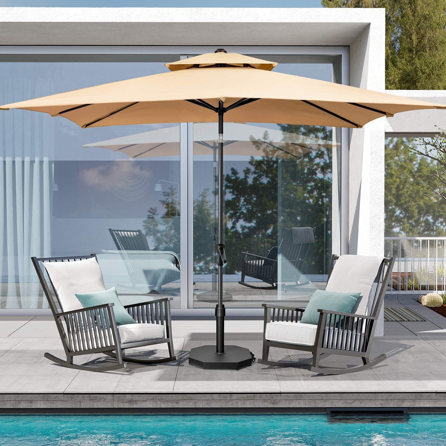 Black 40 lbs octagonal cement market umbrella base with wheels supporting an umbrella between poolside chairs.