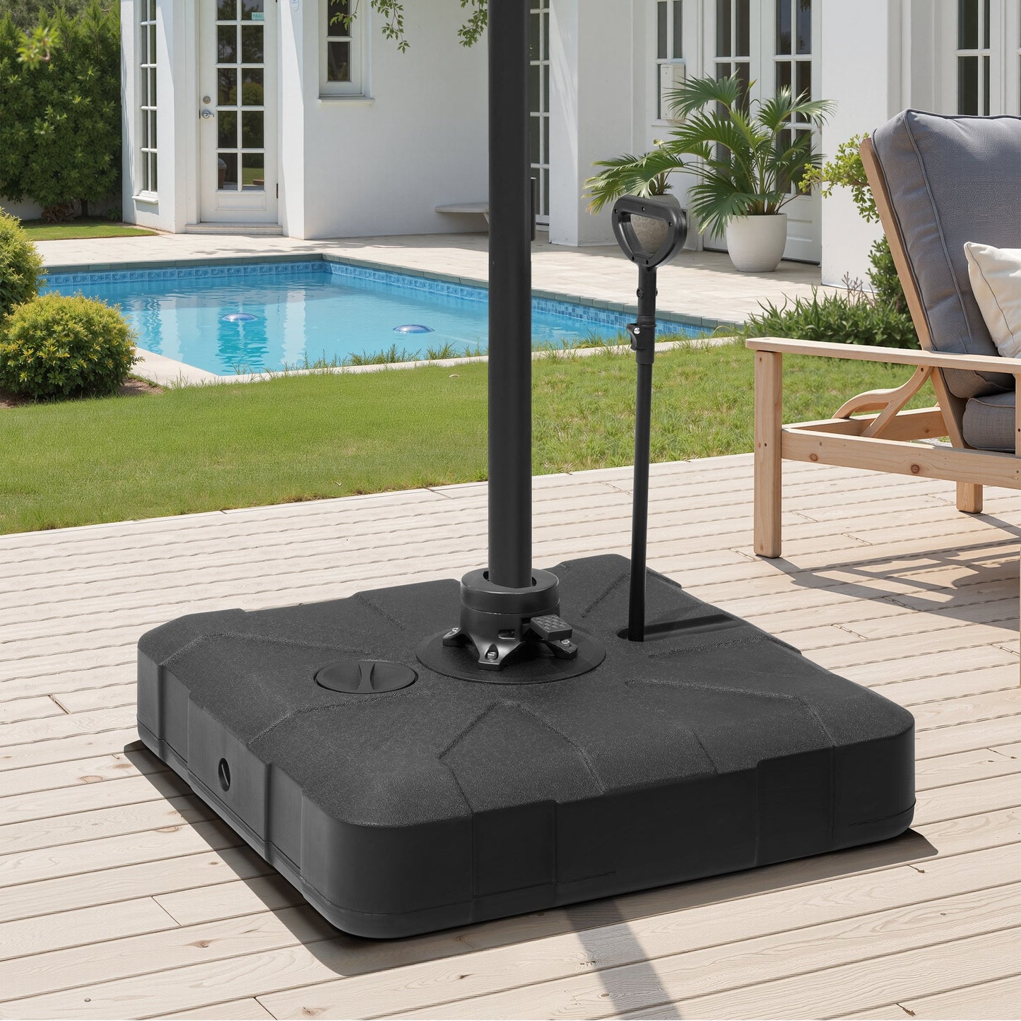 Heavy-duty fillable patio umbrella base with wheels and handle on a poolside deck.