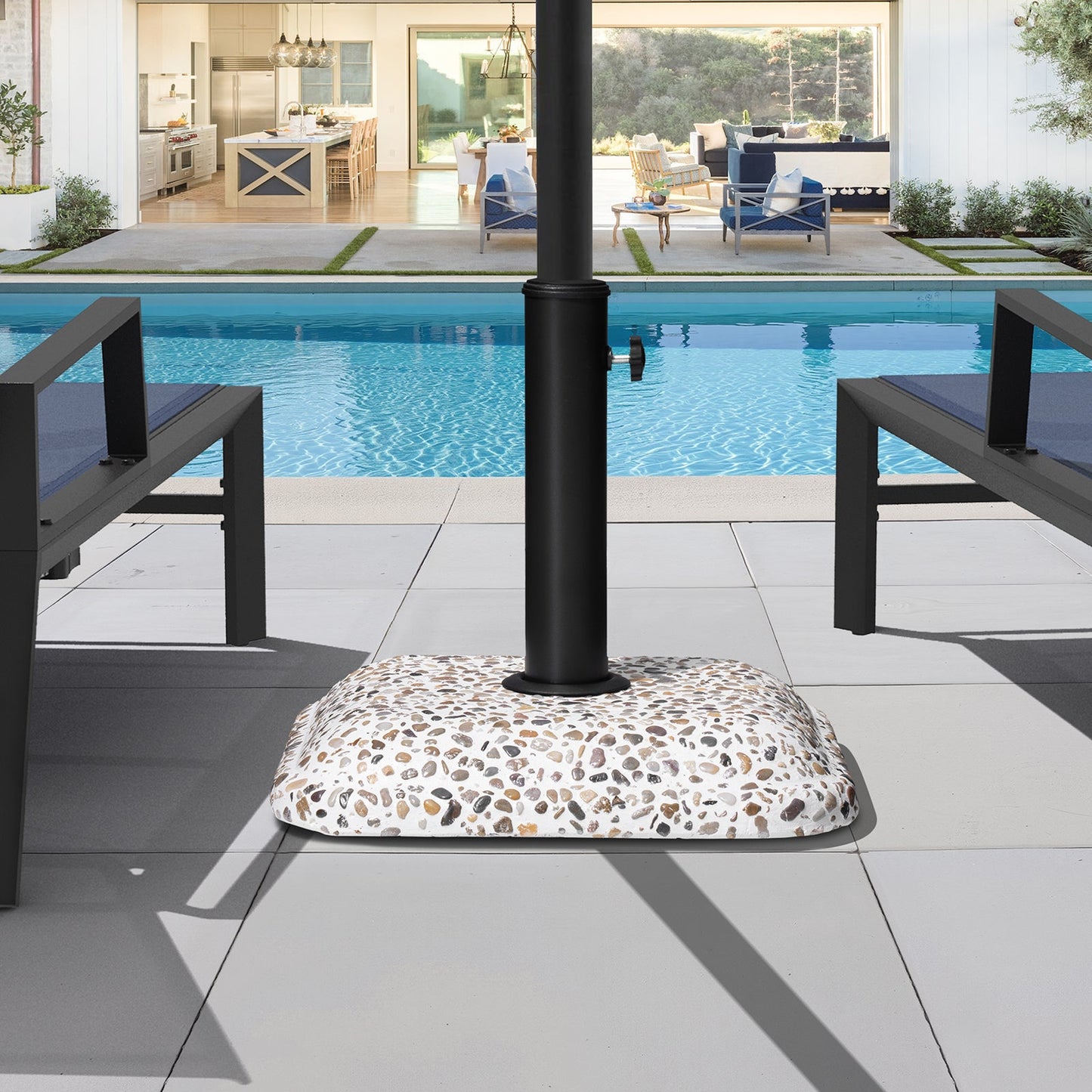 45 lbs cobble cement patio umbrella base without wheels, securing an umbrella by a luxury poolside.