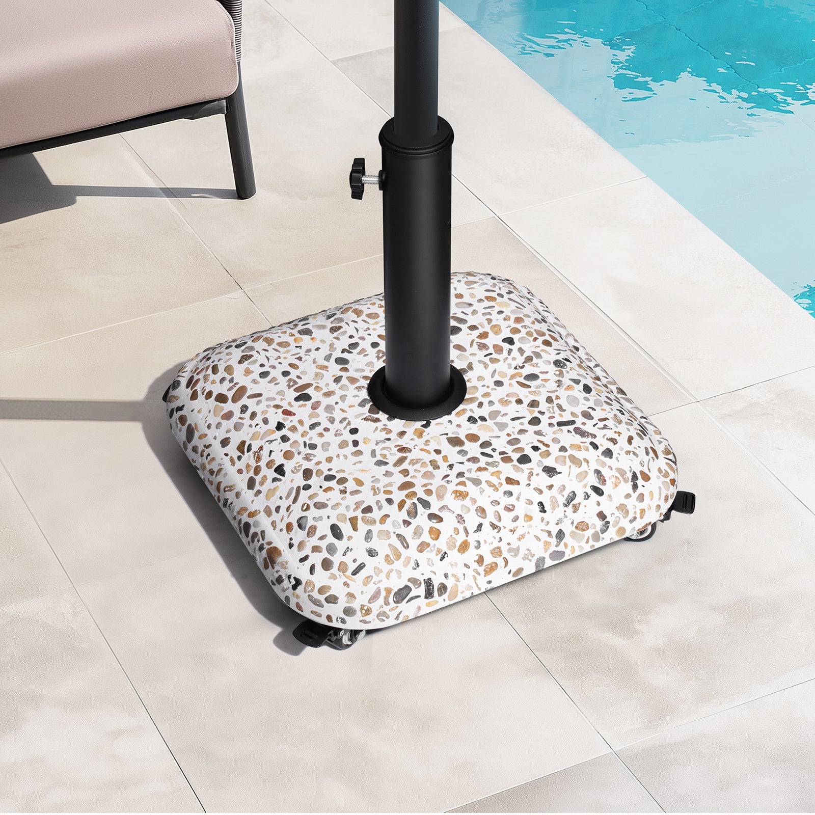 45 lbs cobble cement patio umbrella base with wheels on a sunny poolside patio.